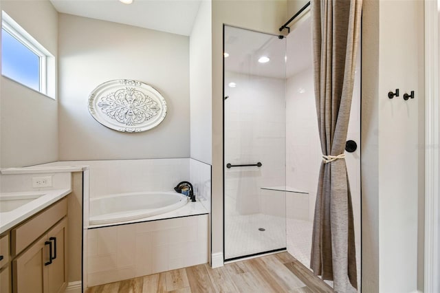 bathroom featuring separate shower and tub, vanity, and wood-type flooring