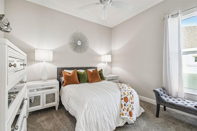 bedroom featuring ceiling fan and dark colored carpet