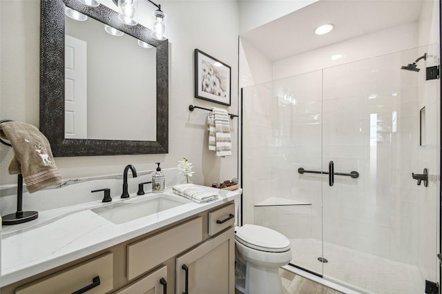 bathroom featuring hardwood / wood-style floors, vanity, toilet, and a shower with door