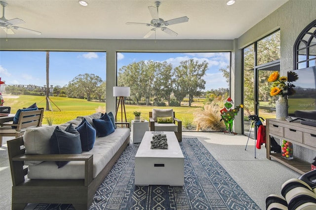 sunroom featuring a wealth of natural light and ceiling fan