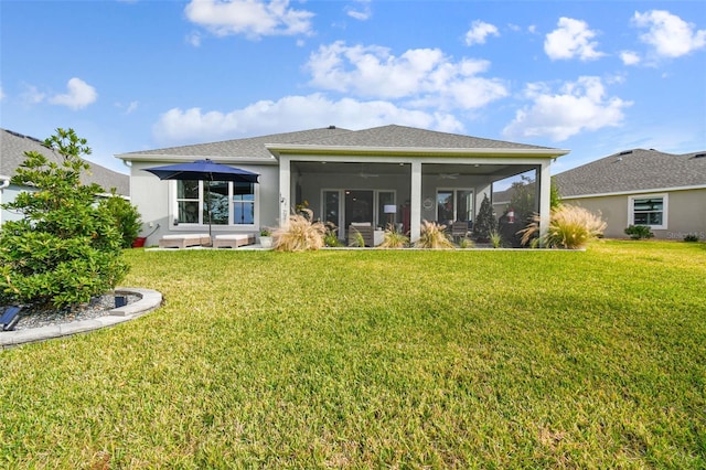 back of house with a lawn and a sunroom