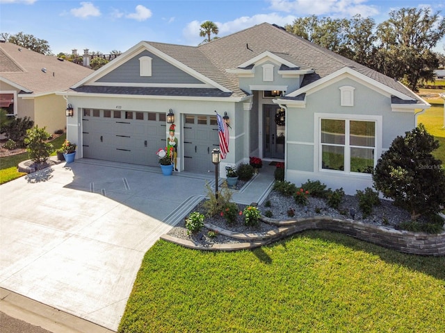 view of front of property featuring a garage and a front yard