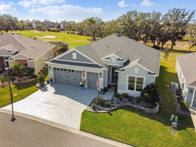 view of front of home featuring central AC unit, a garage, and a front lawn