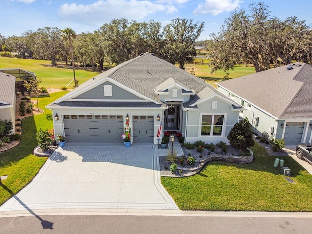 view of front of property with a front yard and a garage