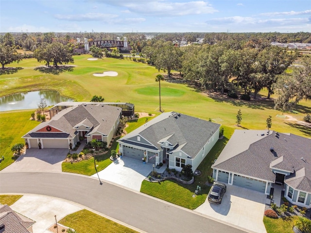 drone / aerial view with view of golf course and a water view