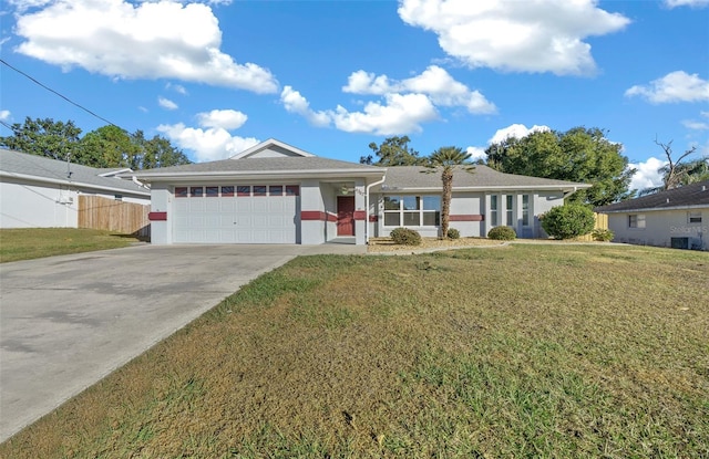 single story home featuring a garage and a front lawn