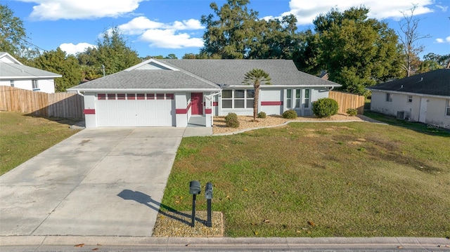 single story home with a garage and a front lawn