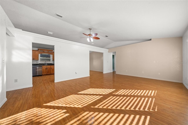 interior space featuring ceiling fan, sink, lofted ceiling, and hardwood / wood-style flooring