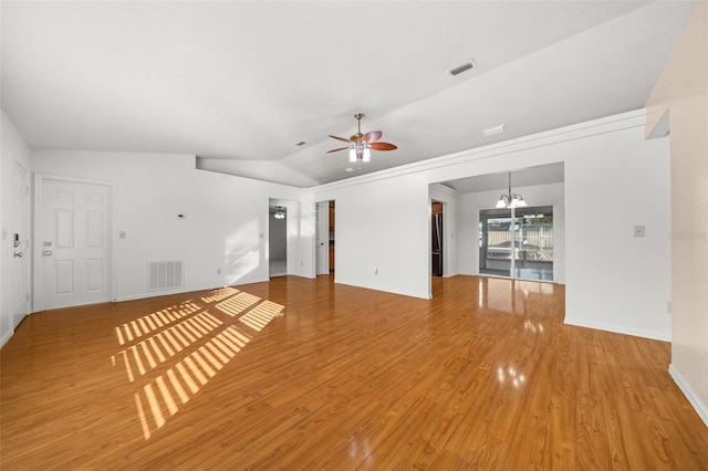 unfurnished living room featuring hardwood / wood-style floors, ceiling fan with notable chandelier, and lofted ceiling