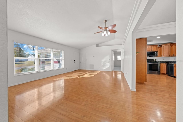 unfurnished living room with ceiling fan, lofted ceiling, a textured ceiling, and light hardwood / wood-style flooring