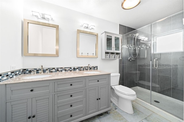 bathroom with vanity, toilet, and a shower with shower door