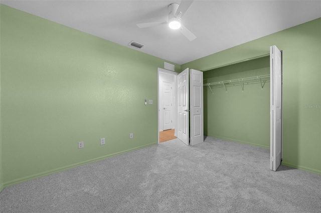 unfurnished bedroom with ceiling fan, a closet, and light colored carpet