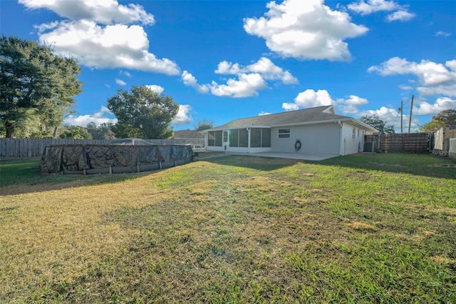 view of yard with central air condition unit, a patio, and a covered pool