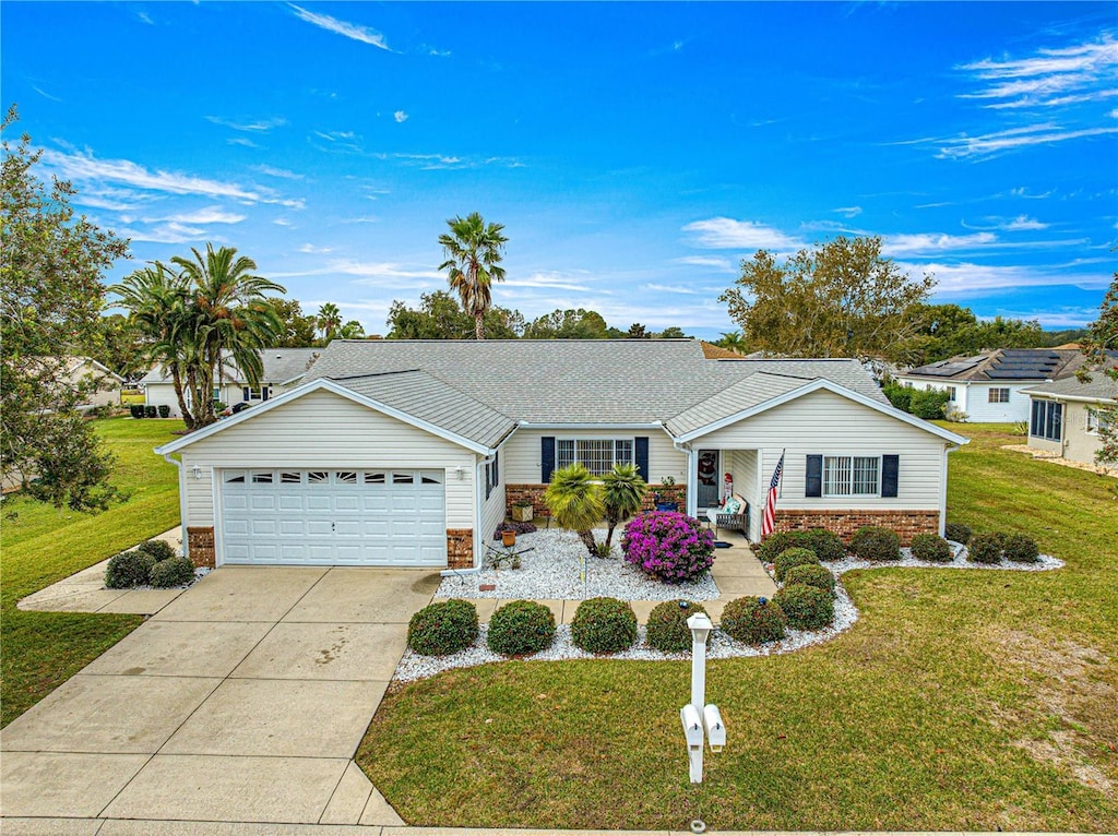 ranch-style home with a garage and a front yard