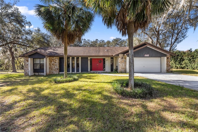 ranch-style house featuring a garage and a front lawn