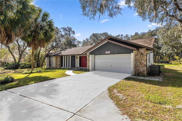 ranch-style home with a garage and a front lawn