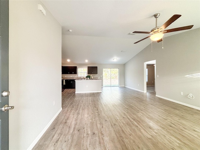 unfurnished living room featuring light wood-type flooring, ceiling fan, and lofted ceiling