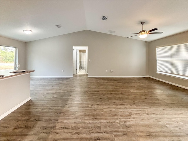 unfurnished living room featuring dark hardwood / wood-style floors, ceiling fan, and lofted ceiling