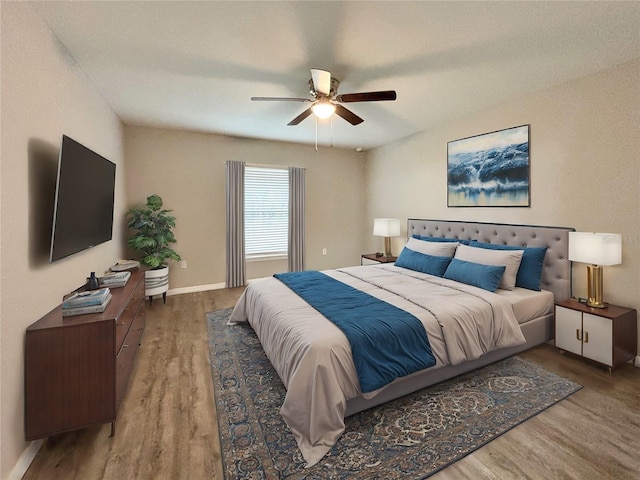 bedroom with hardwood / wood-style flooring and ceiling fan