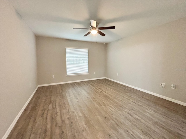 empty room featuring wood-type flooring and ceiling fan