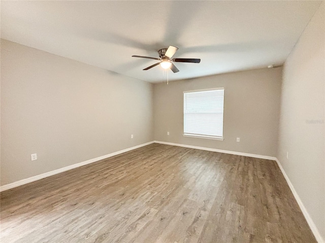 unfurnished room with ceiling fan and hardwood / wood-style flooring