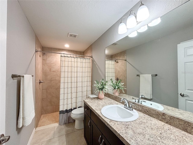 bathroom featuring vanity, tile patterned flooring, toilet, a textured ceiling, and curtained shower