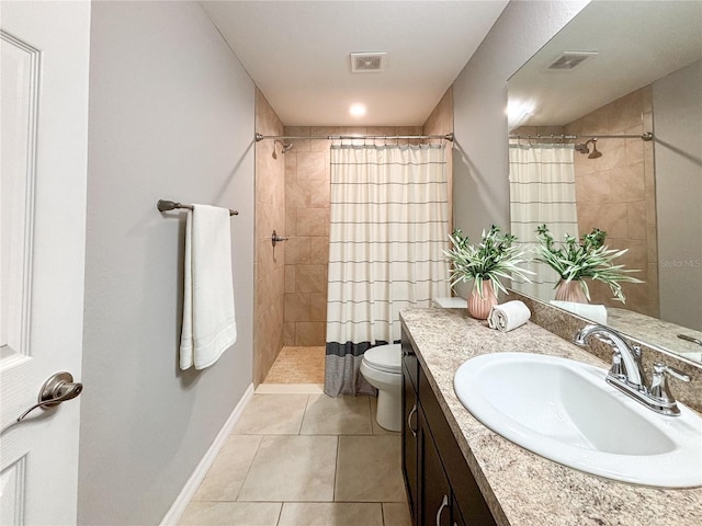 bathroom with tile patterned flooring, a shower with curtain, vanity, and toilet