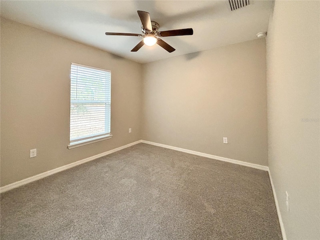 carpeted spare room featuring ceiling fan