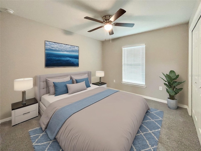 carpeted bedroom with ceiling fan and a closet