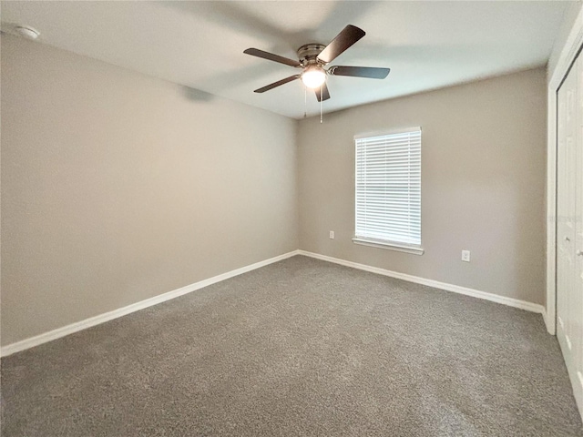 carpeted spare room with ceiling fan