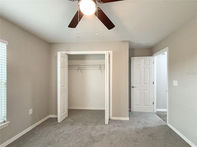 unfurnished bedroom featuring a closet, light colored carpet, and ceiling fan