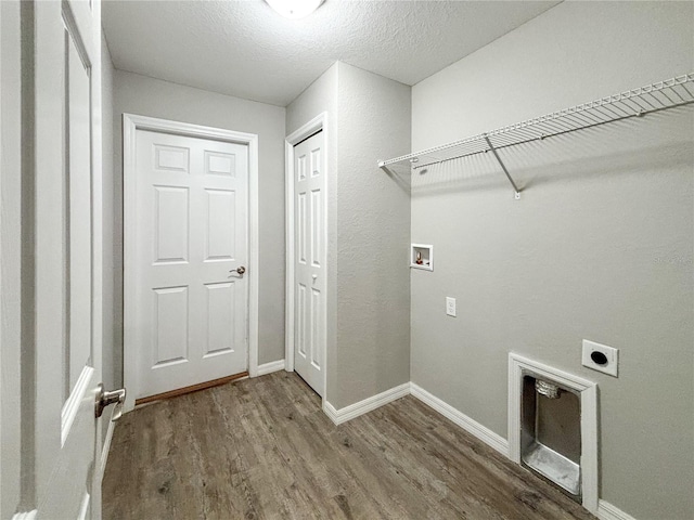 laundry room featuring hardwood / wood-style floors, hookup for an electric dryer, a textured ceiling, and washer hookup