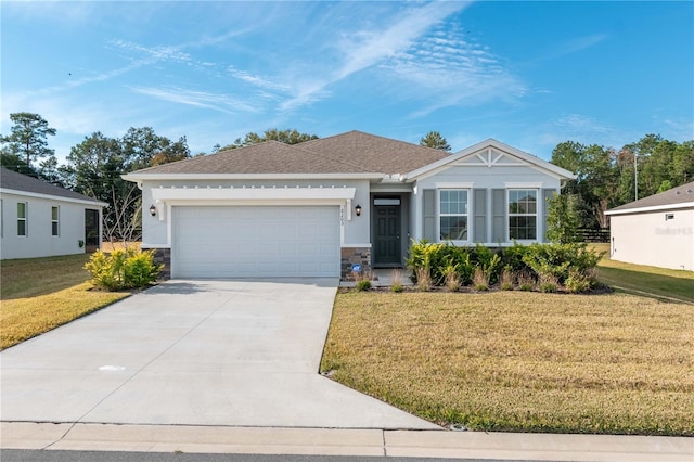 ranch-style house featuring a front yard and a garage