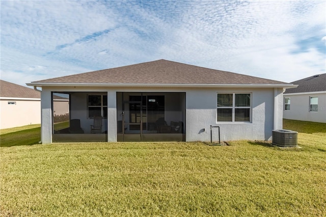 back of property featuring a yard, central air condition unit, and a sunroom