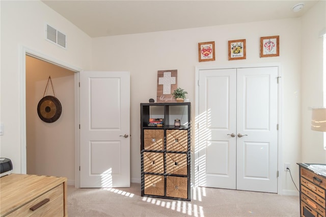 bedroom with a closet and light colored carpet