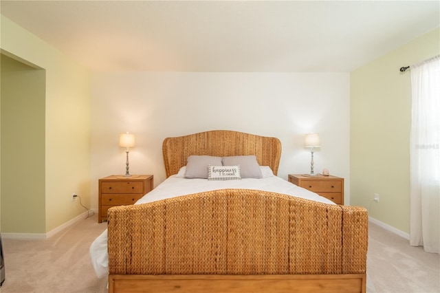 bedroom featuring light colored carpet