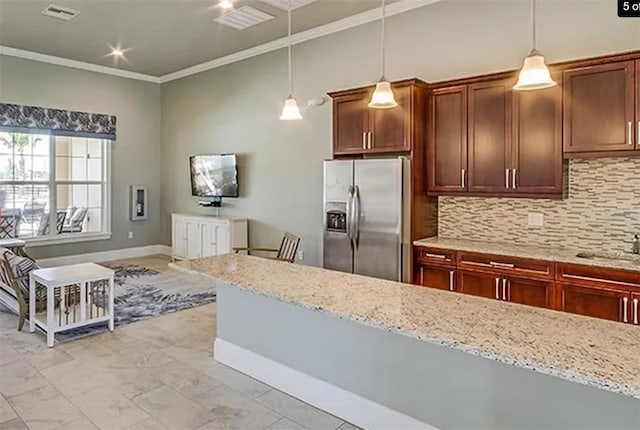 kitchen featuring stainless steel refrigerator with ice dispenser, backsplash, pendant lighting, and light stone countertops