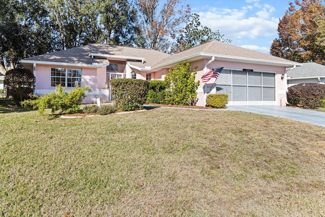 single story home featuring a garage and a front yard