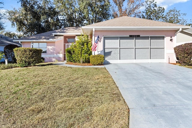 single story home featuring a garage and a front yard