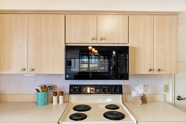 kitchen with backsplash, electric range oven, and light brown cabinets