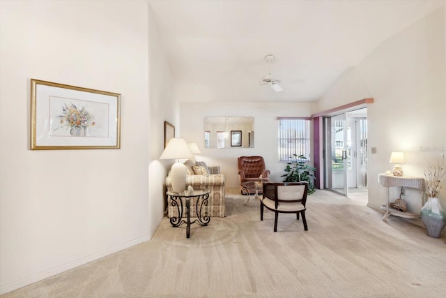 sitting room featuring ceiling fan, lofted ceiling, and light carpet