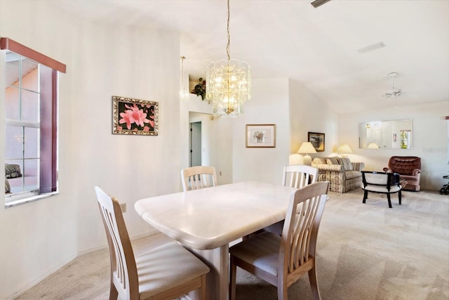 dining space with light colored carpet and a notable chandelier