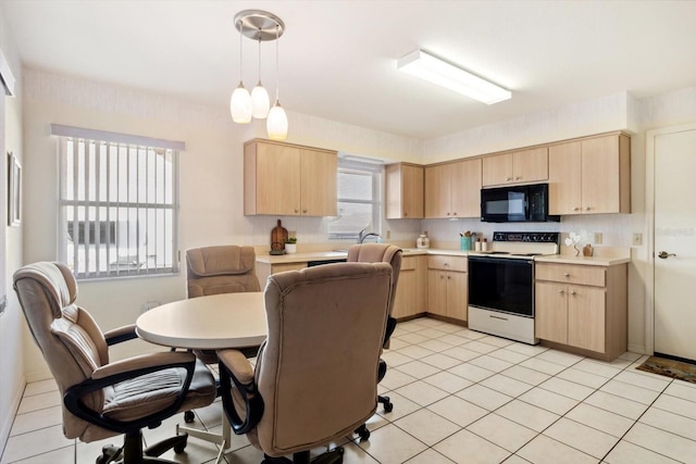 kitchen featuring light brown cabinetry, hanging light fixtures, light tile patterned floors, and white range with electric cooktop