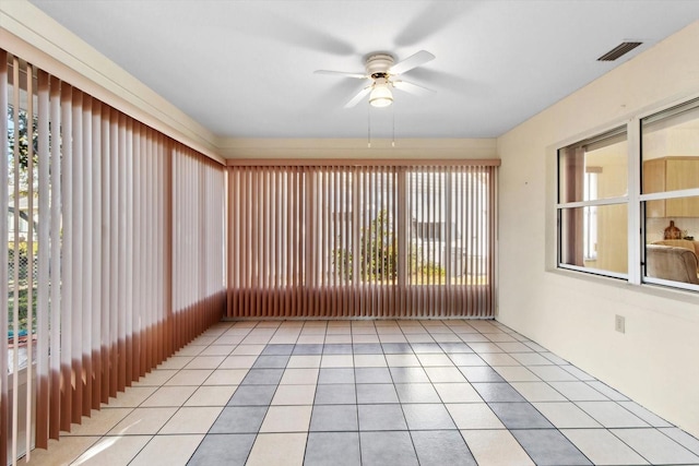 unfurnished sunroom with ceiling fan