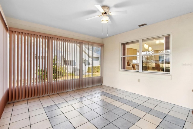 unfurnished sunroom with ceiling fan