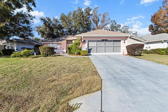 single story home featuring a garage and a front lawn