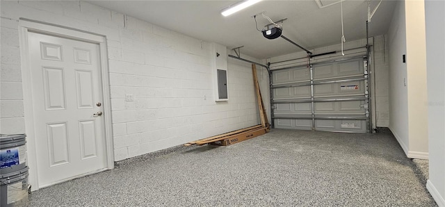 garage with a garage door opener, concrete block wall, and electric panel