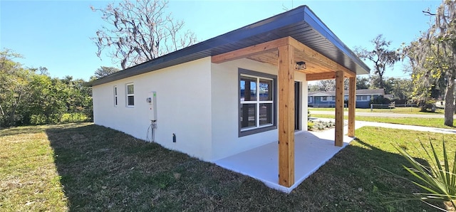 view of home's exterior with a yard and stucco siding