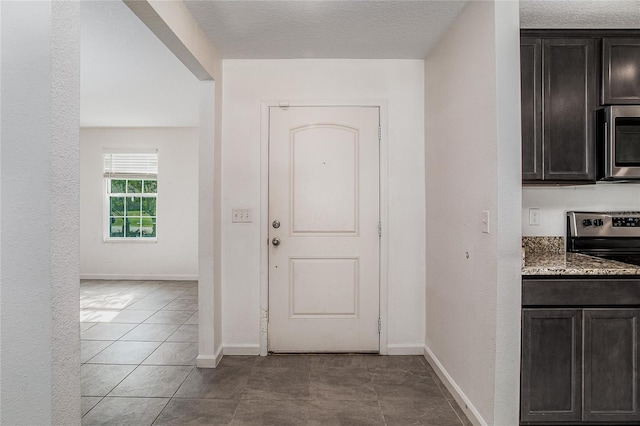 interior space featuring light tile patterned floors and a textured ceiling