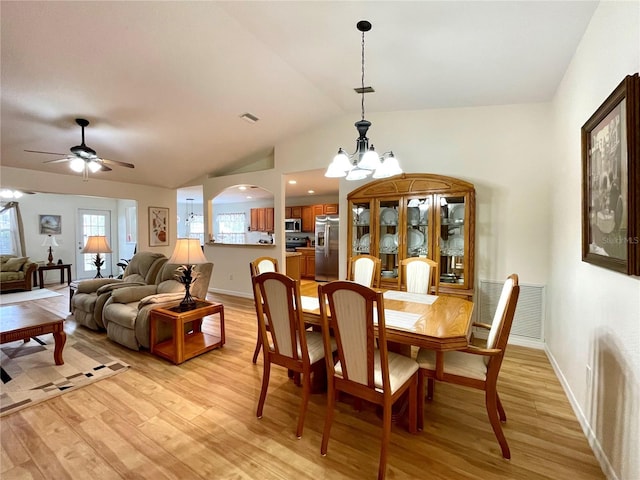 dining space featuring lofted ceiling, light wood-style flooring, and visible vents